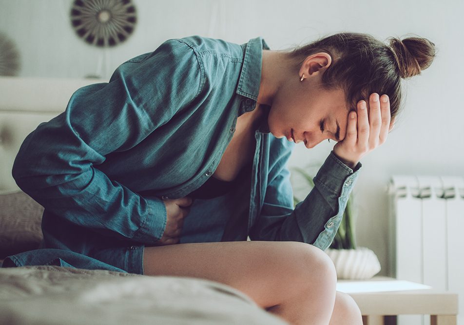 Donna avverte i sintomi della cistite, tra cui fastidio o dolore durante la minzione