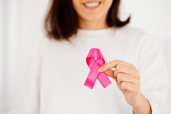 Donna sottoposta a chemioterapia che sorride con Nastro Rosa