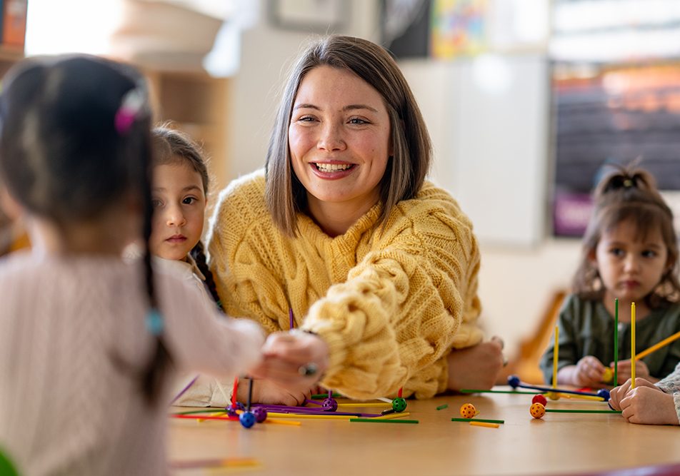 maestra-con-bambini-incubazione-streptococco Maestra sorridente insieme ai suoi piccoli alunni, durante il periodo di incubazione dello streptococco