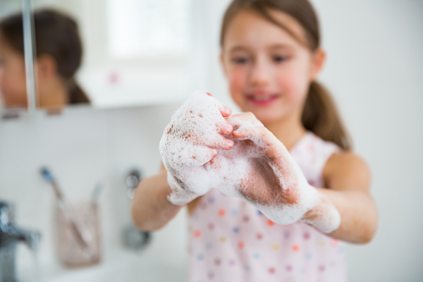 Bambina si lava le mani per prevenire il contagio da streptococco