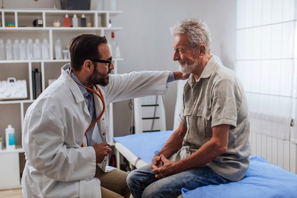 paziente-con-neoplasia-ricevendo-supporto-dopo-visita-da-oncologo Paziente con neoplasia prostatica in atto che riceve supporto emotivo da parte dell’oncologo dopo la visita di controllo in studio
