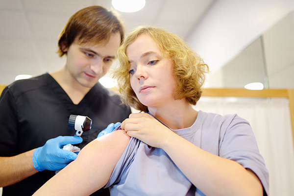 Giovane paziente durante una visita dermatologica durante il periodo della convalescenza dopo l’asportazione di un neo