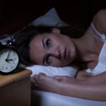 Donna nel suo letto che soffre di insonnia
