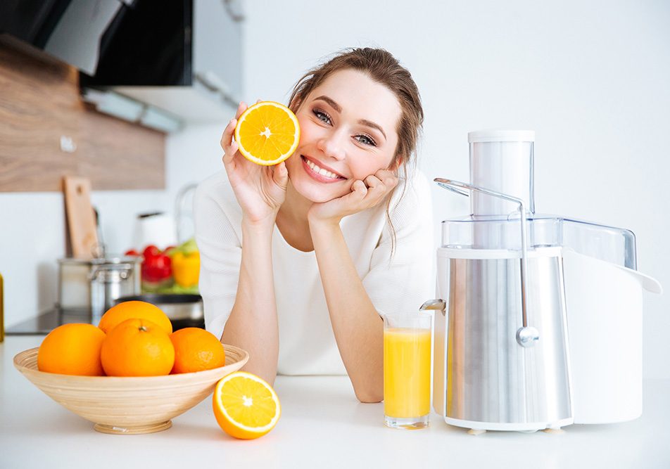 donna-nutrendosi-di-acido-ascorbico-attraverso-spremuta-di-arancia Dona in una cucina domestica che si nutre di acido ascorbico, ovvero vitamina C, attraverso una spremuta di arancia fatta in casa