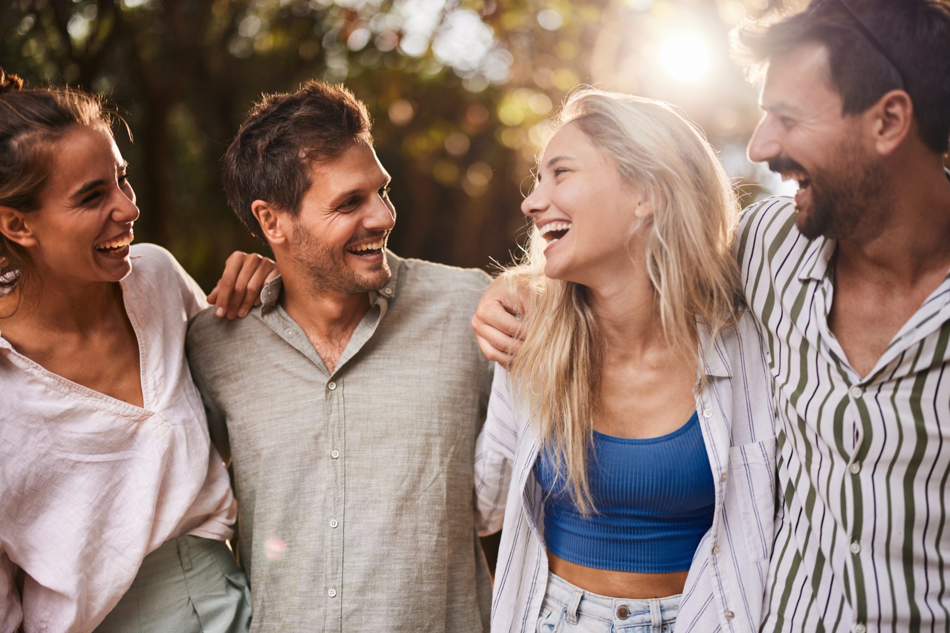 gruppo di due donne e due uomini ridono abbracciati