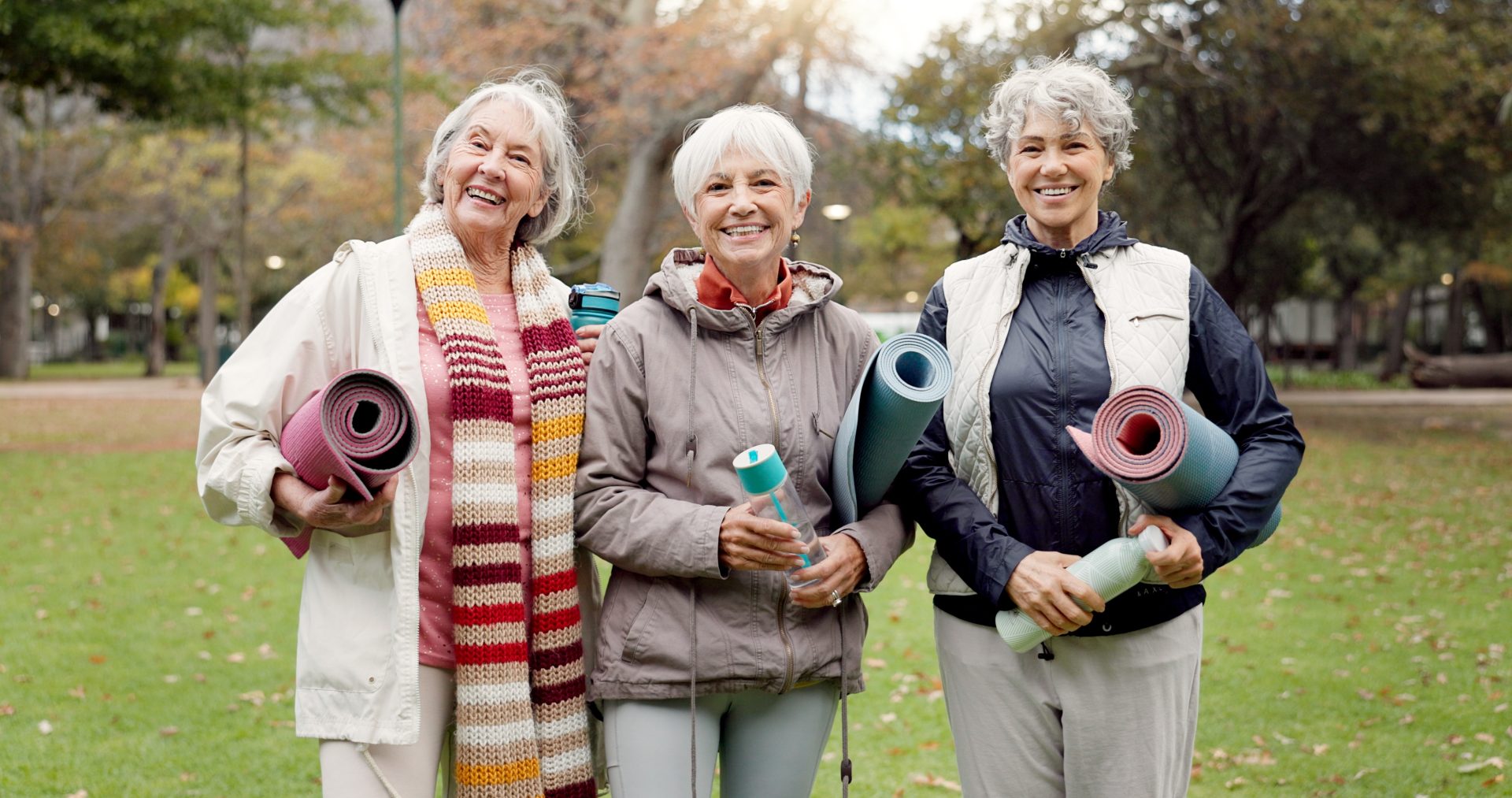 tre donne con materassini da pilates su prato
